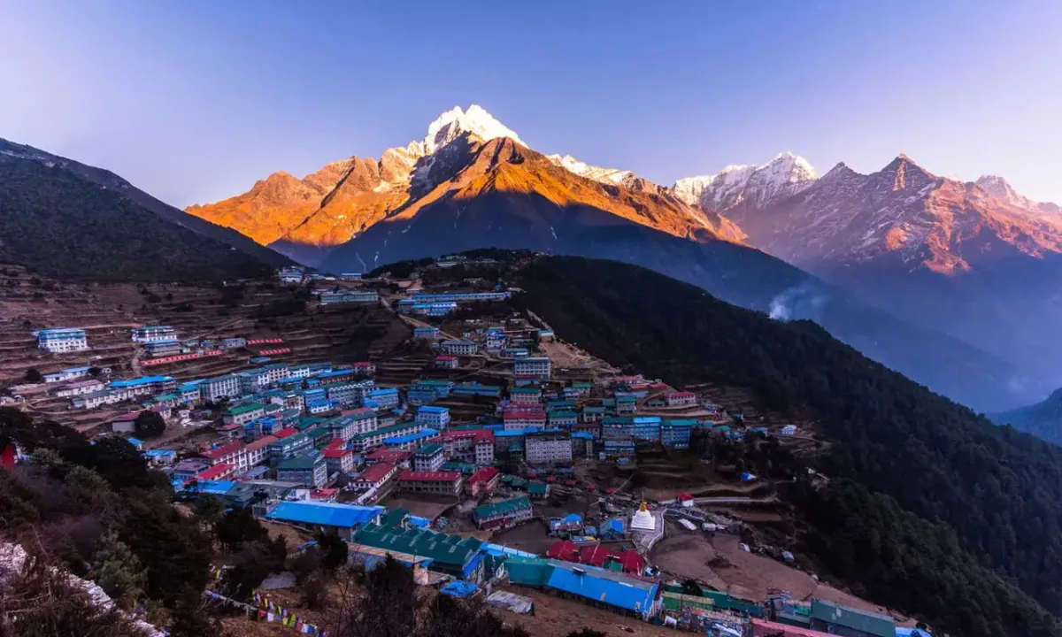 Namche Bazaar, Nepal, with snow-capped mountains at sunrise.
