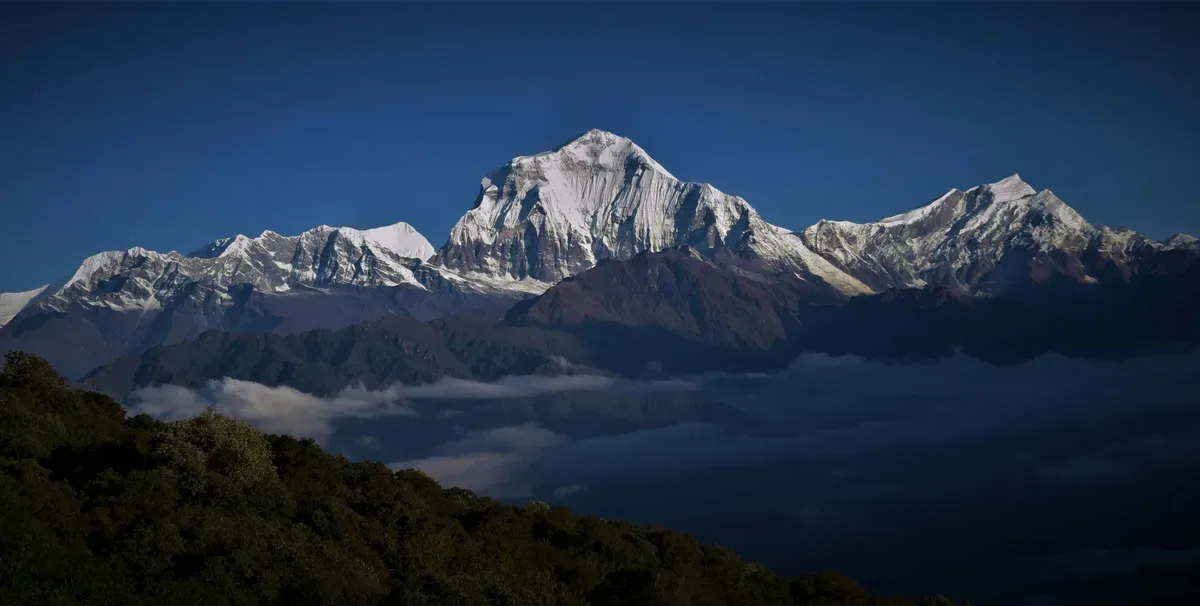 Himalayan mountain range above clouds panoramic view Poon Hill trek Annapurna region Nepal with Mt. Dhaulagiri in the background