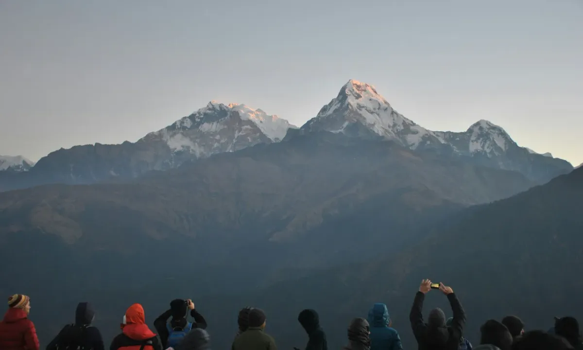 Trekkers watching sunrise over Annapurna and Machapuchare from Poon Hill 3210m Ghorepani Nepal