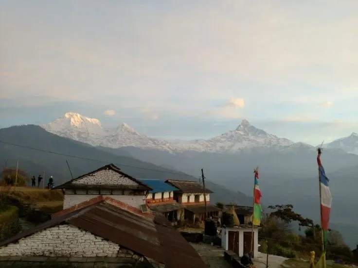 Dhampus village teahouse lodge prayer flags with Annapurna and Machapuchare peaks Annapurna foothills Nepal