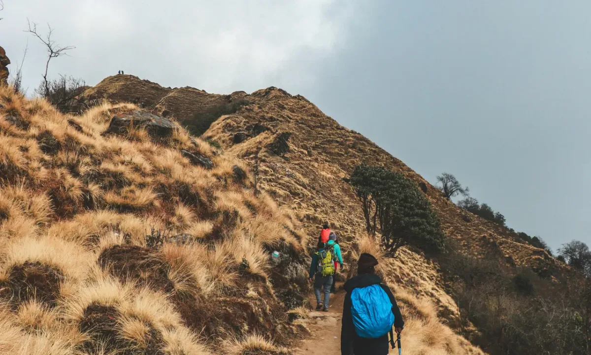 Trekkers hiking along dry alpine ridge on Mardi Himal Trek Annapurna Nepal