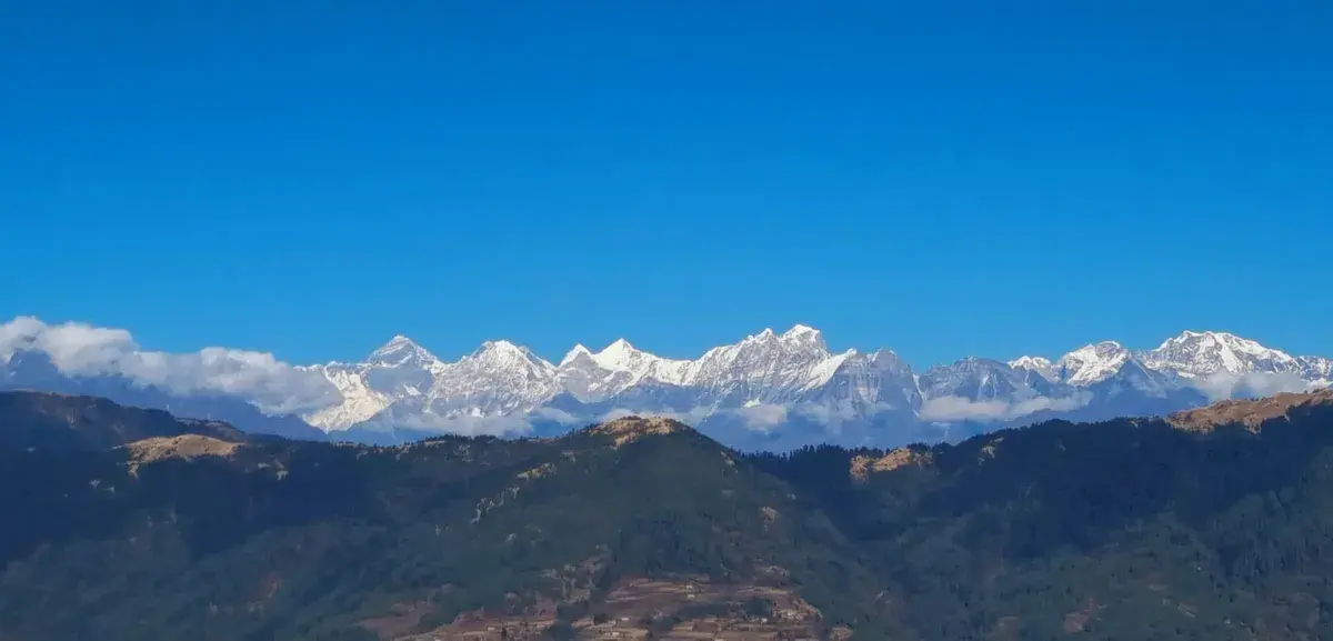 Panoramic view of snow-covered Himalayan mountain range under clear blue sky from Pikey Peak summit, Solukhumbu, Nepal