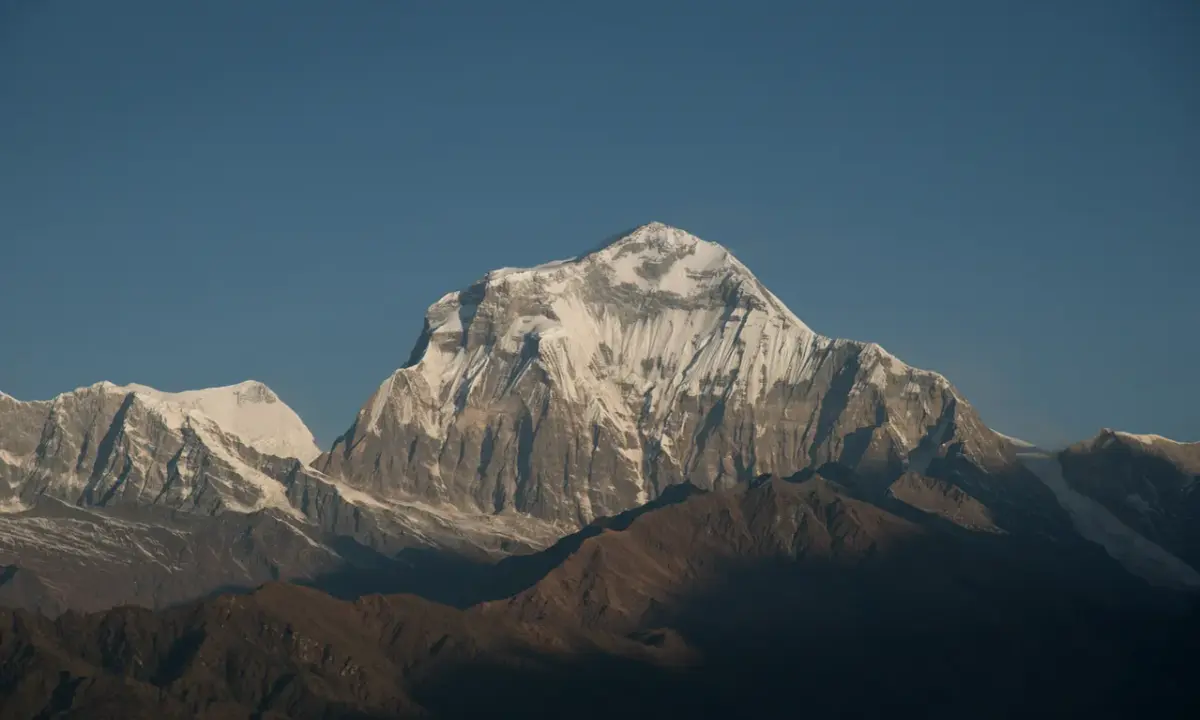 Snow-capped Dhaulagiri peak under clear blue sky viewed from Khopra Ridge trek, Annapurna region Nepal