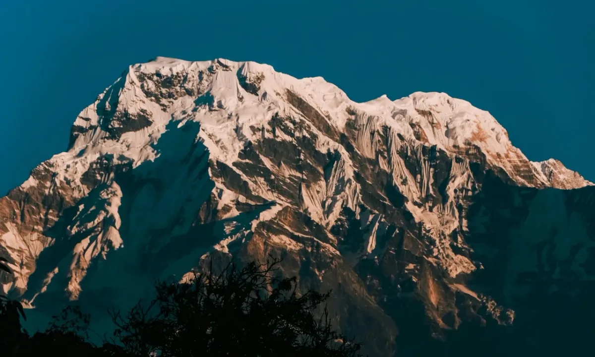 Close-up view of towering Annapurna South snow-covered peak from Khopra Ridge, Annapurna Sanctuary Nepal