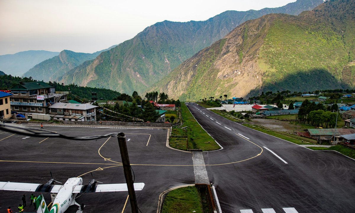 Tenzing-Hillary Airport runway in Lukla with Himalayan mountains in the background, the starting point of Everest Base Camp Trek