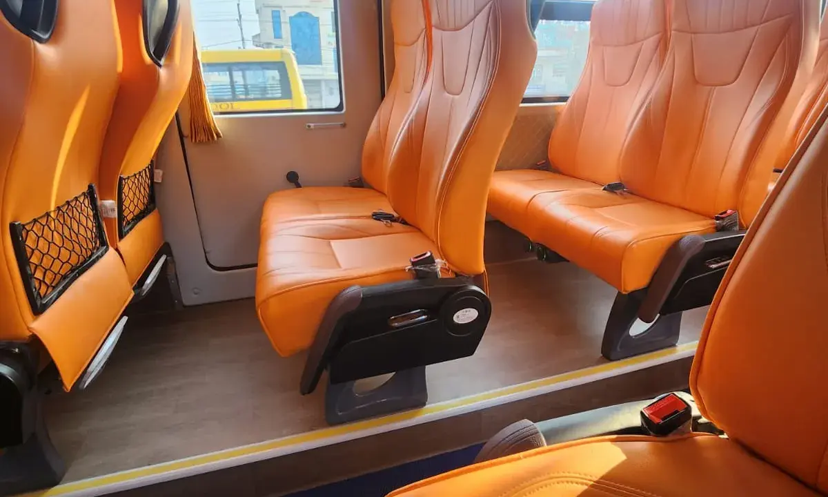 Inside the EV Grand Cruiser — the orange seats, wide windows, and clean cabin were not what a Rs. 874 ticket prepared me for.