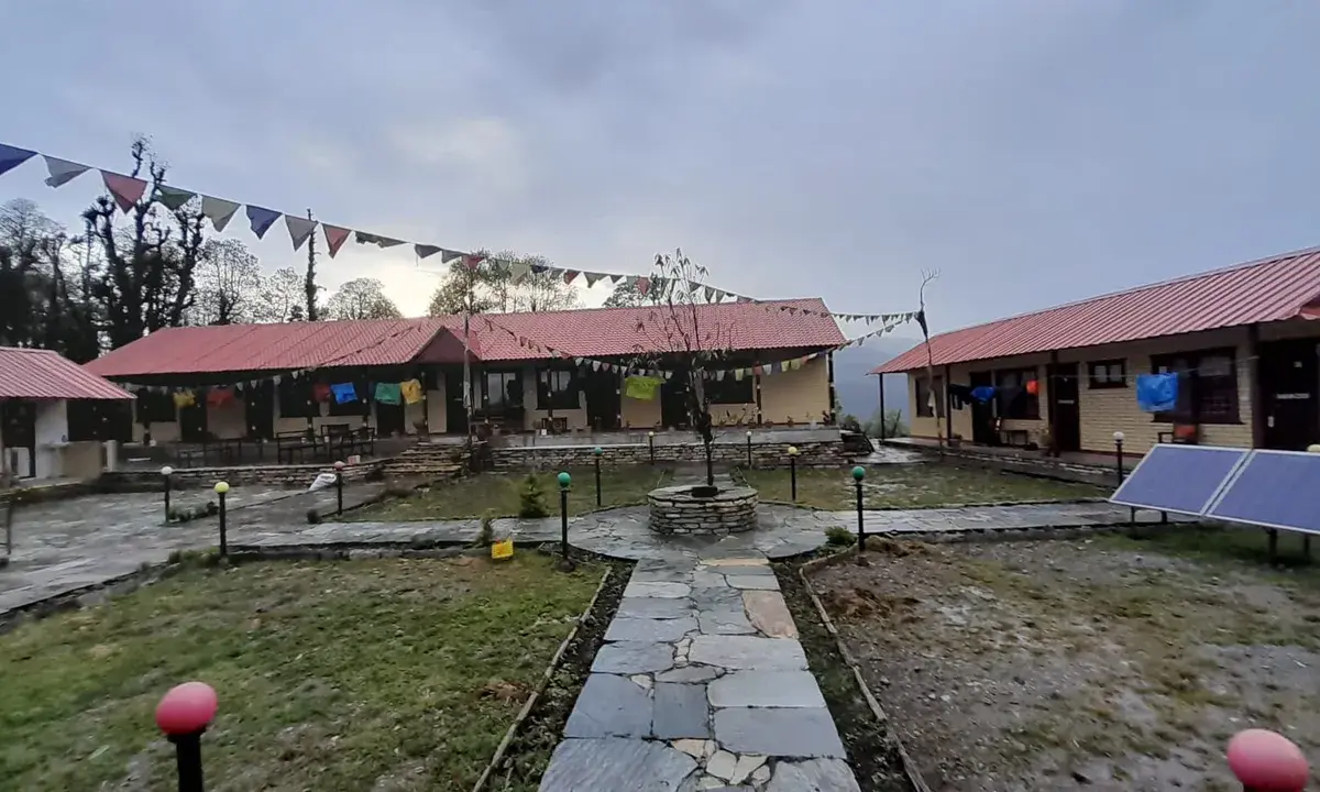 The lodge at Ghorepani — quiet, damp, and still. The prayer flags the only colour in an otherwise grey afternoon.