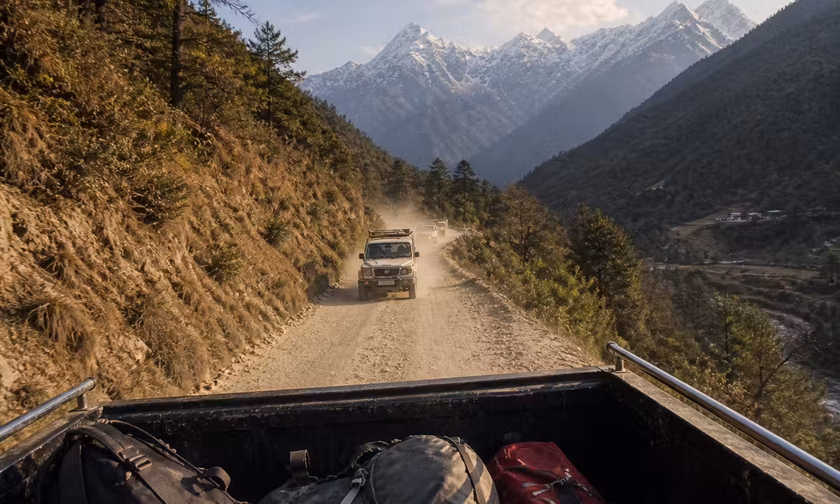 View from the back of a pickup truck on a mountain road in the Solukhumbu foothills Nepal heading toward the Everest trekking trail