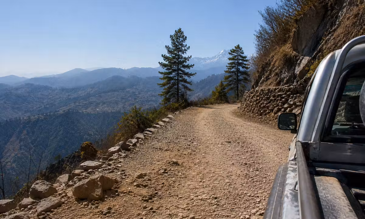 View from a pickup truck on a steep mountain road heading toward Thamdanda in the Solukhumbu foothills, Nepal