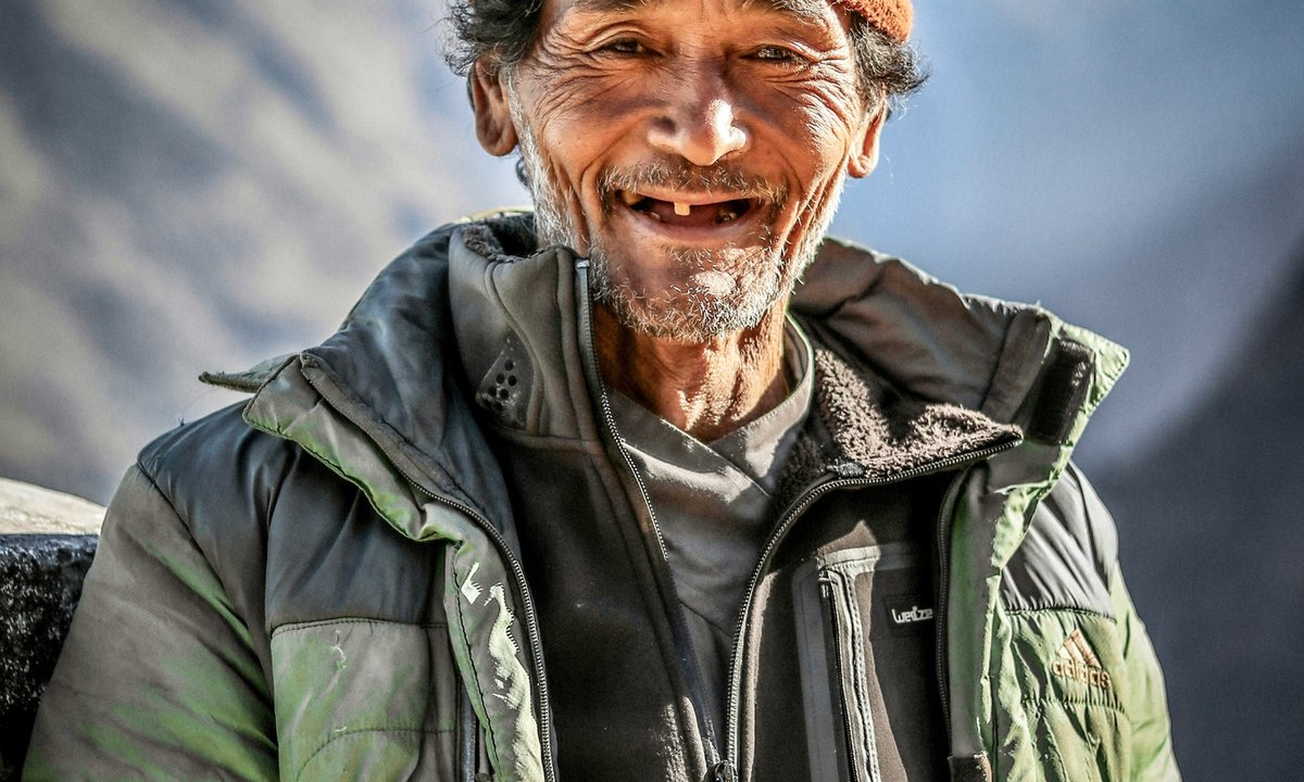 Tamang man smiling in the high mountain hills of Nepal representing the Tamang ethnic community