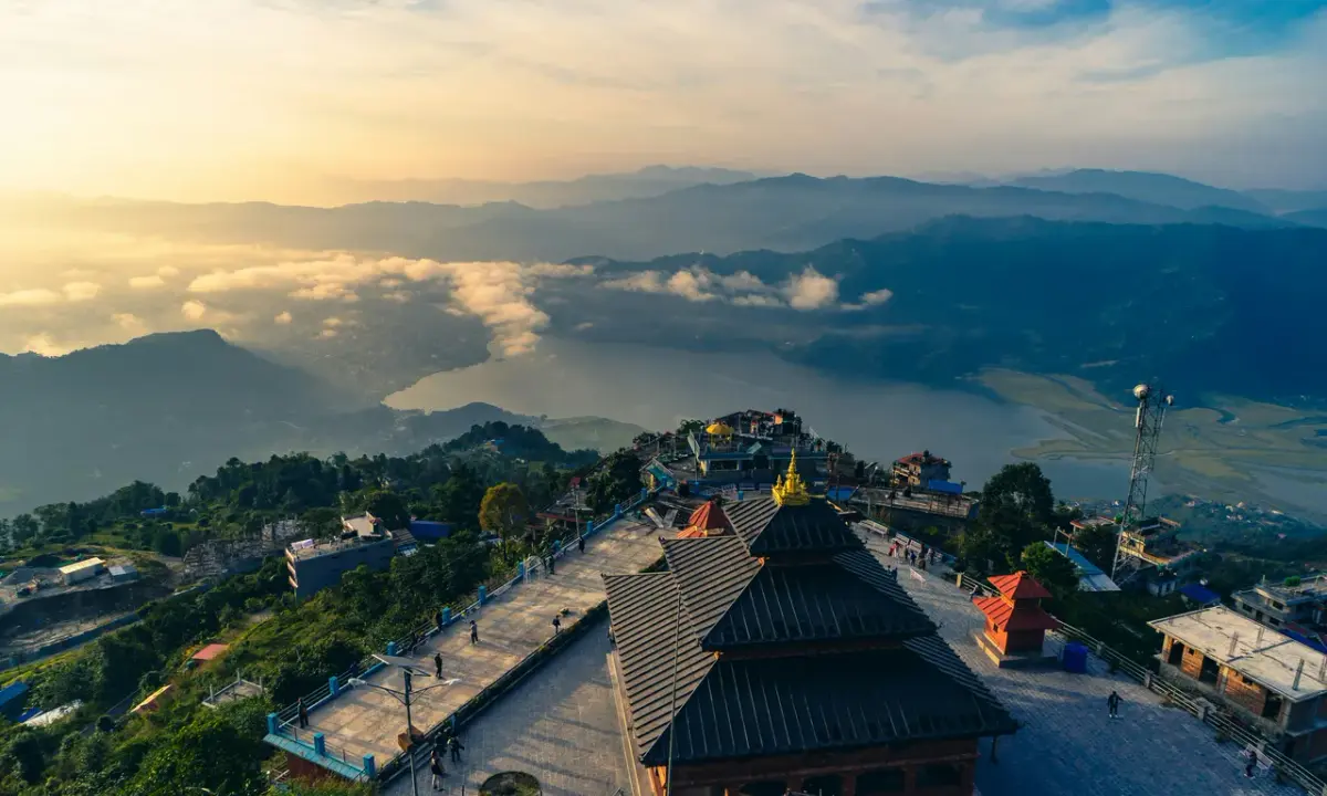 This aerial landscape view shows the Sarangkot View Tower area in Pokhara, Nepal, at sunrise.