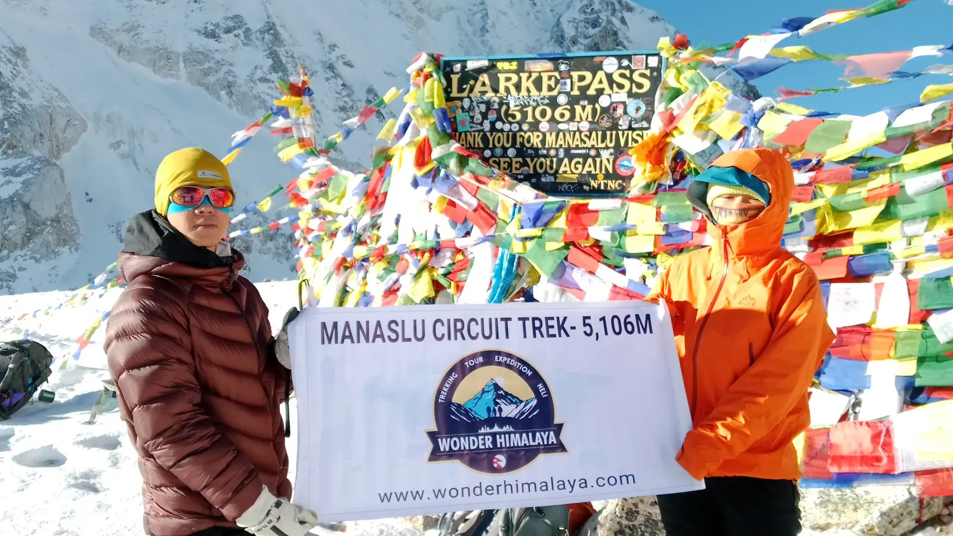 Hikers celebrate at Larke Pass (5,106m) on the Manaslu Circuit Trek, Nepal.