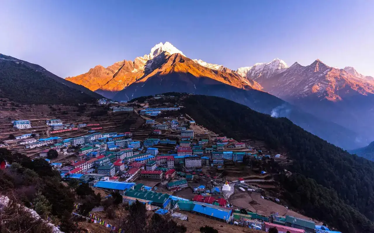 Namche Bazaar, Nepal, with snow-capped mountains at sunrise.