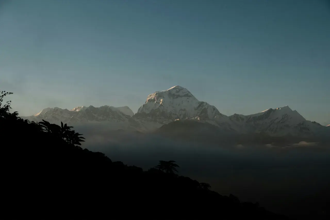 Silhouette of Himalayan peaks at dusk from Poon Hill viewpoint Ghorepani trek Annapurna Nepal