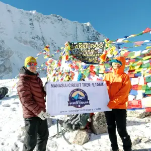 Hikers celebrate at Larke Pass (5,106m) on the Manaslu Circuit Trek, Nepal.