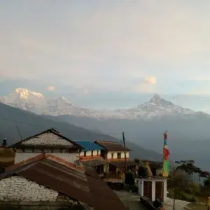 Dhampus village teahouse lodge prayer flags with Annapurna and Machapuchare peaks Annapurna foothills Nepal