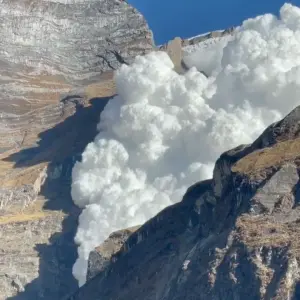 Avalanche snow cloud crashing down Himalayan mountain face Kapuche Lake trek Annapurna Nepal