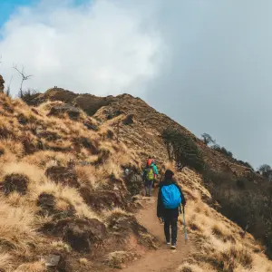 Trekkers hiking along dry alpine ridge on Mardi Himal Trek Annapurna Nepal