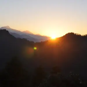 Golden sunrise over layered dark Himalayan ridgelines viewed from Khopra Danda ridge, Annapurna region Nepal