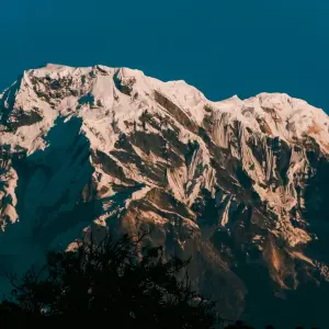 Close-up view of towering Annapurna South snow-covered peak from Khopra Ridge, Annapurna Sanctuary Nepal