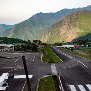 Tenzing-Hillary Airport runway in Lukla with Himalayan mountains in the background, the starting point of Everest Base Camp Trek
