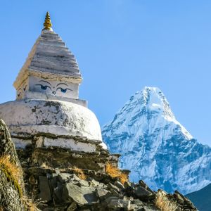Buddhist stupa along the Everest Base Camp trekking trail with snow-capped Ama Dablam peak in the background, Khumbu region Nepal