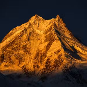 Manaslu summit glowing golden at sunset, eighth highest peak in the world, Nepal Himalayas