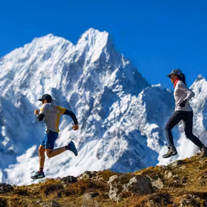 Two trail runners on Manaslu Circuit ridge with Himalayan snow peaks, Nepal trail running