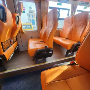 Inside the EV Grand Cruiser — the orange seats, wide windows, and clean cabin were not what a Rs. 874 ticket prepared me for.