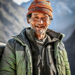 Tamang man smiling in the high mountain hills of Nepal representing the Tamang ethnic community