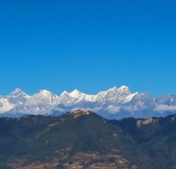Panoramic view of snow-covered Himalayan mountain range under clear blue sky from Pikey Peak summit, Solukhumbu, Nepal