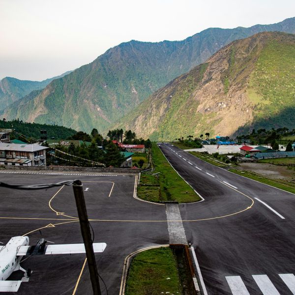 Tenzing-Hillary Airport runway in Lukla with Himalayan mountains in the background, the starting point of Everest Base Camp Trek