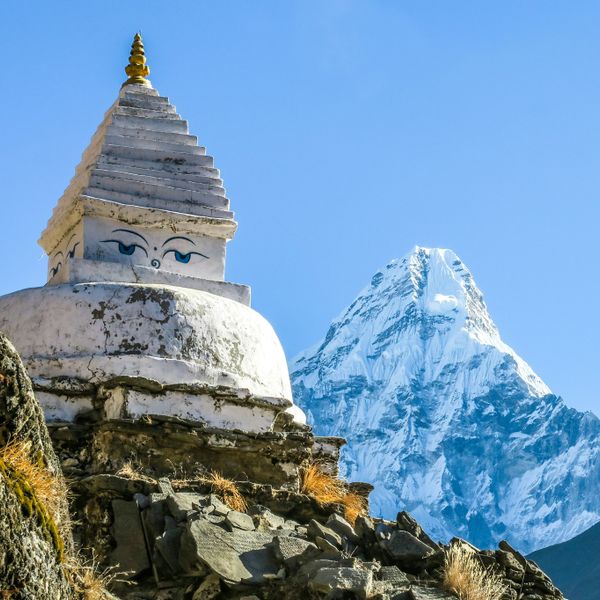 Buddhist stupa along the Everest Base Camp trekking trail with snow-capped Ama Dablam peak in the background, Khumbu region Nepal