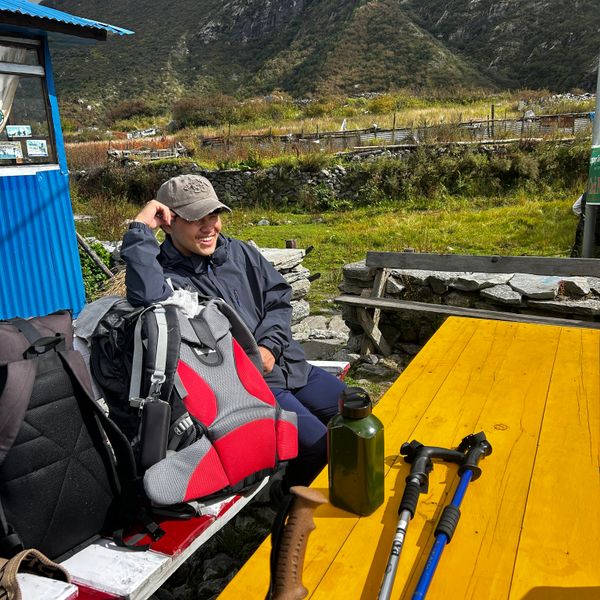 Trekker resting at a teahouse with backpack and trekking gear on the Langtang Valley Trek