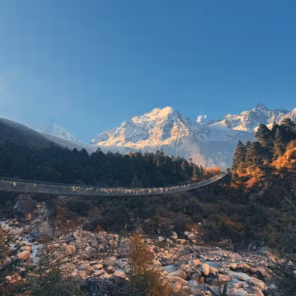 Budhi Gandaki river valley with forested hillsides and Himalayan peaks on the Manaslu Circuit Trek
